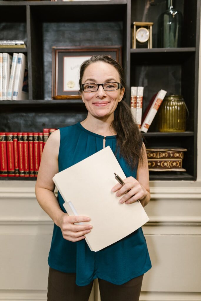 a woman in blue sleeveless shirt smiling at the camera