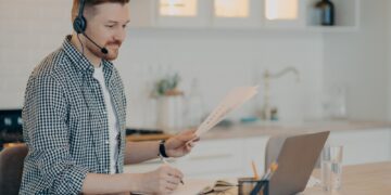 Smiling guy during online meeting while working at home