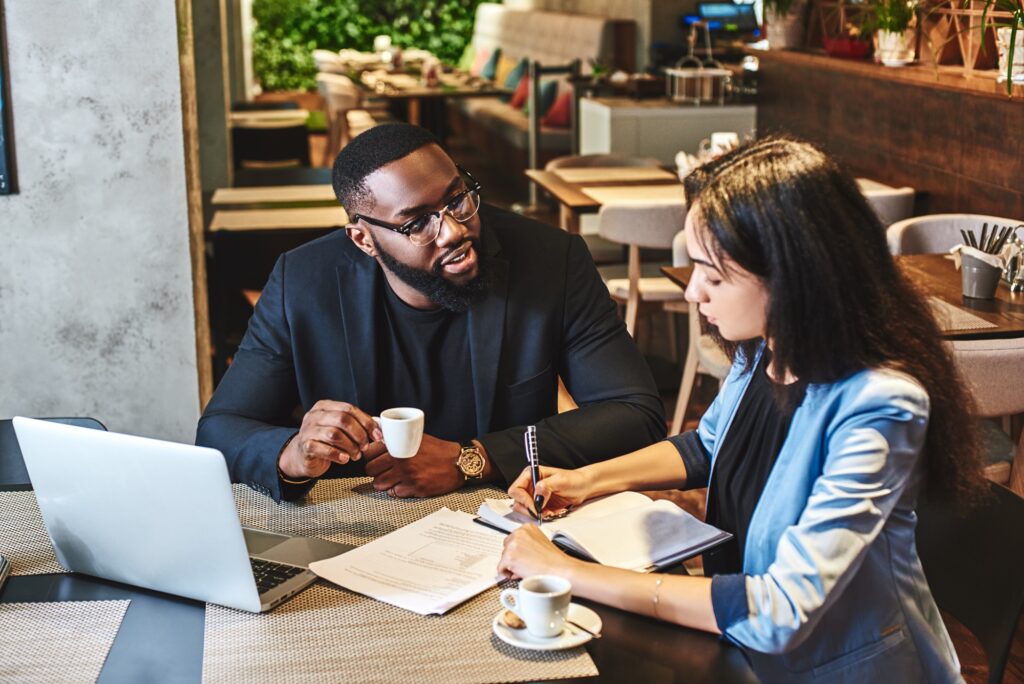 You'll be happier at work when you make some friends there. Two colleagues having lunch in