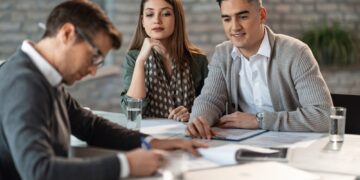 Young couple on a meeting with their insurance agent.