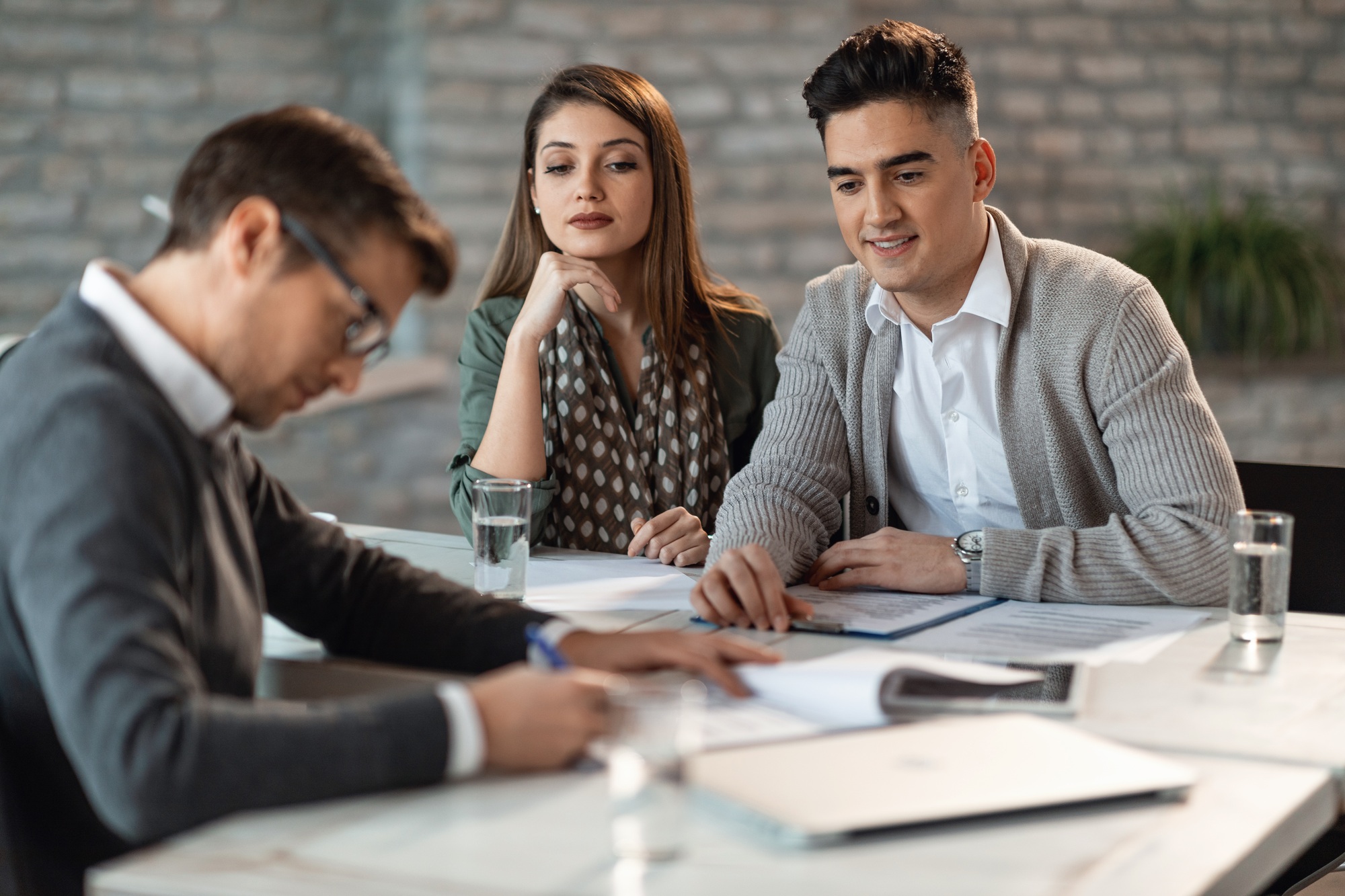 Young couple on a meeting with their insurance agent.